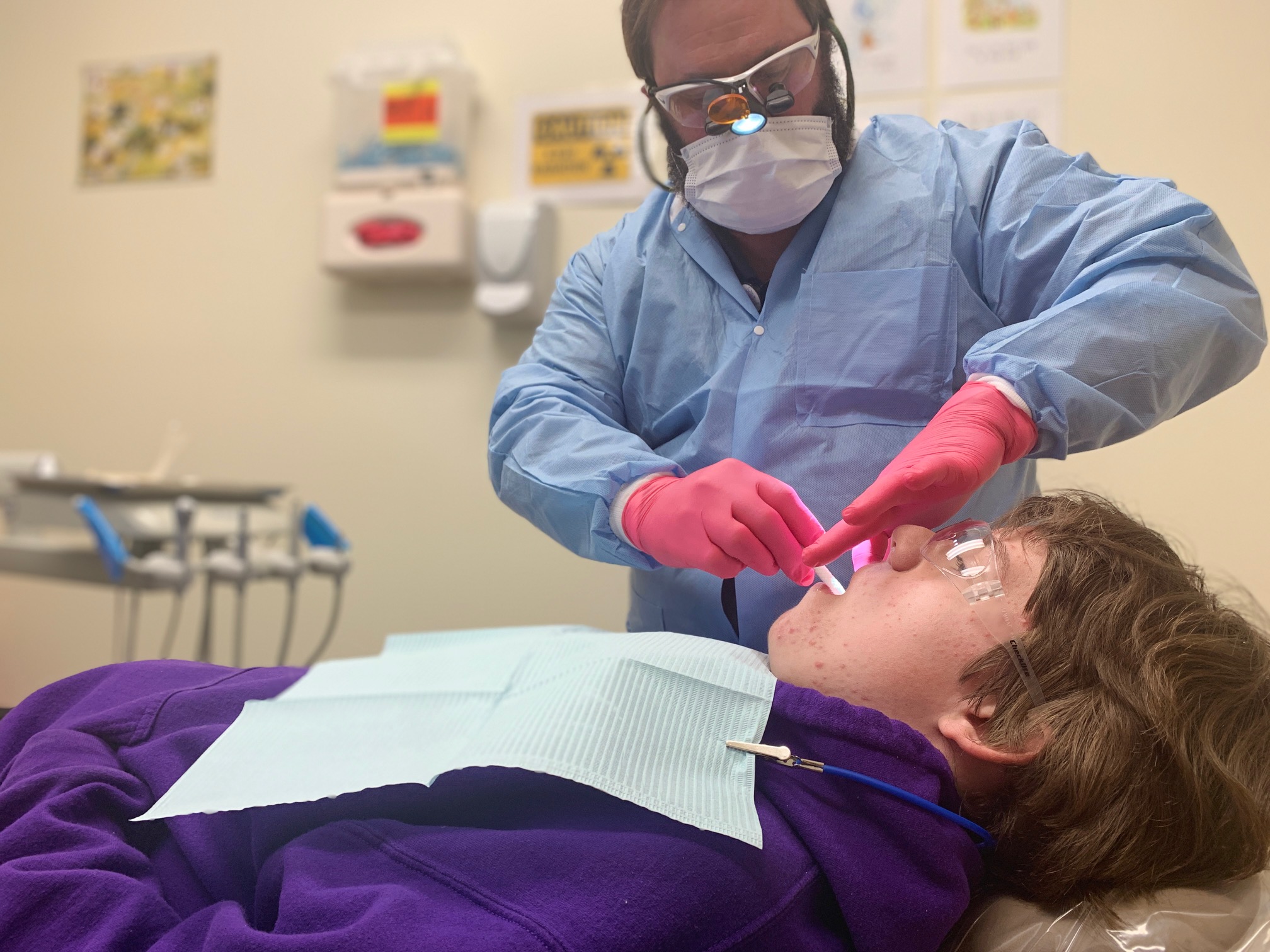 dentist examining child patient's mouth
