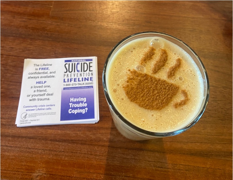 Cup of coffee with suicide prevention pamphlet